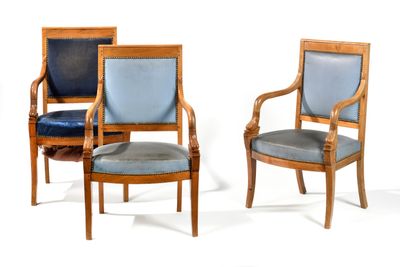 three wooden chairs with blue upholstered leather seats on a white background
