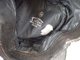a close up of a black hat with a white label on it