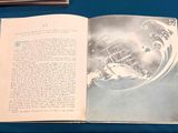 an open book with a picture of a ship on it