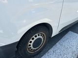 a white van that is parked on the side of the road