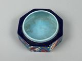 a blue bowl sitting on top of a white table