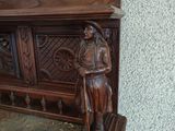 a statue of a man standing next to a wooden bench