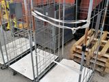 two metal carts with wheels are sitting on the ground next to pallets of pallets