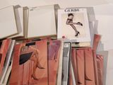 a lot of magazines on a table with a woman in a dress