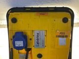 a yellow box with a black cord attached to it