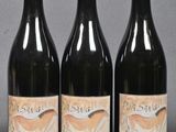 three bottles of wine sitting next to each other on a table