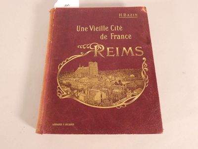 book on a white table with a red cover and gold lettering