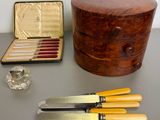four knives and a box on the table
