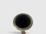 a black and silver vase on a white surface