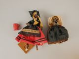 two dolls sitting next to each other on a table