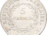 a close up of a silver coin with a wreath on it