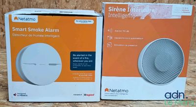 two boxes of a smart smoke alarm sitting on a table