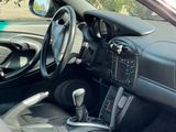 a car dashboard with a steering wheel and dashboard controls
