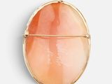 an image of a gold locke with a pink stone in the center
