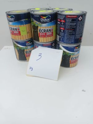 several cans of paint sitting on top of a table next to a sign