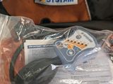 a bag of oranges and a remote control in it