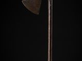 an old axe with a wooden handle on a black background