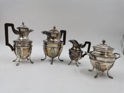 trois théières en métal plaqué argent et une cafetière, posées sur des socles