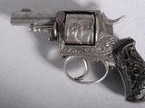 a gun that is sitting on a table with a ring on it