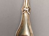 a silver spoon with a handle on a table