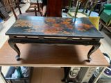 a table that has been painted with flowers on it