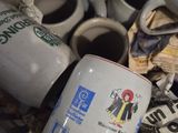 a pile of coffee cups and mugs sitting on a table