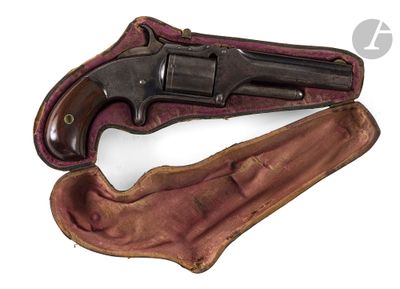 an old revolver with a leather case on a white background