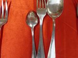 a silver tray with spoons, forks and spoons on it