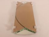 a mirror with a curved design on it on a table
