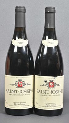 two bottles of wine sitting next to each other on top of a table