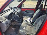 a red car that has a bunch of items in it