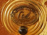 a close up of a gold plate with a clock on it