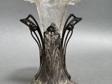 an image of a silver vase sitting on top of a table
