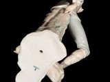 a figurine of a man laying on his stomach