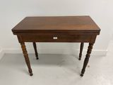 a small wooden table with a drawer on top of it