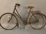a old bicycle with a basket on the back of it