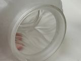 a person ' s foot sticking out of a clear cup