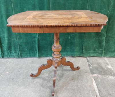 an old wooden table with a wooden top on a stone floor