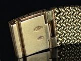 an image of a close up of a watch on a black surface