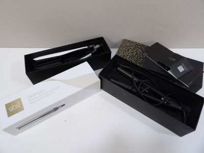 a black box with a pair of scissors inside of it