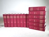 six red books stacked on top of each other on a white surface