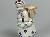 a figurine of a woman holding a basket