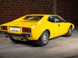 a yellow car that is parked in a garage