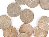 plusieurs pièces de monnaie sont disposées en cercle sur une surface blanche