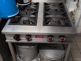 a blue bucket sitting on top of a stove in a kitchen