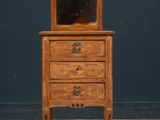 an old wooden dresser with a mirror on top of it