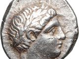 a close up of a silver coin with a woman ' s head on it