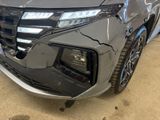 the front end of a gray honda cr - v parked in a garage
