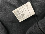 a label on the back of a black sweater