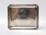 a silver plate with a picture of a dog on it